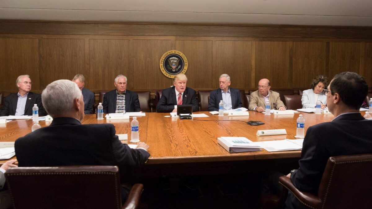President Trump and cabinet officials seated around a conference table at Camp David
