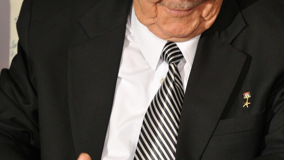 Former Cuban leader Raúl Castro, seated, gesturing with both hands during a 2012 meeting