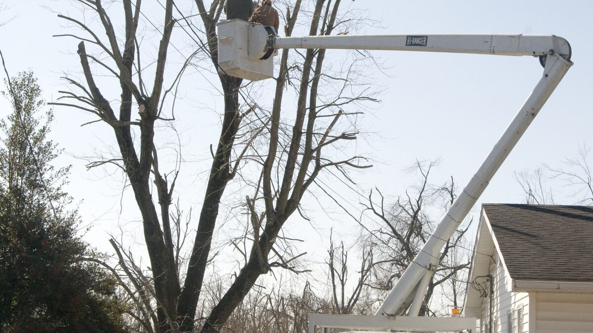 Utility crews repairing ice-damaged power lines