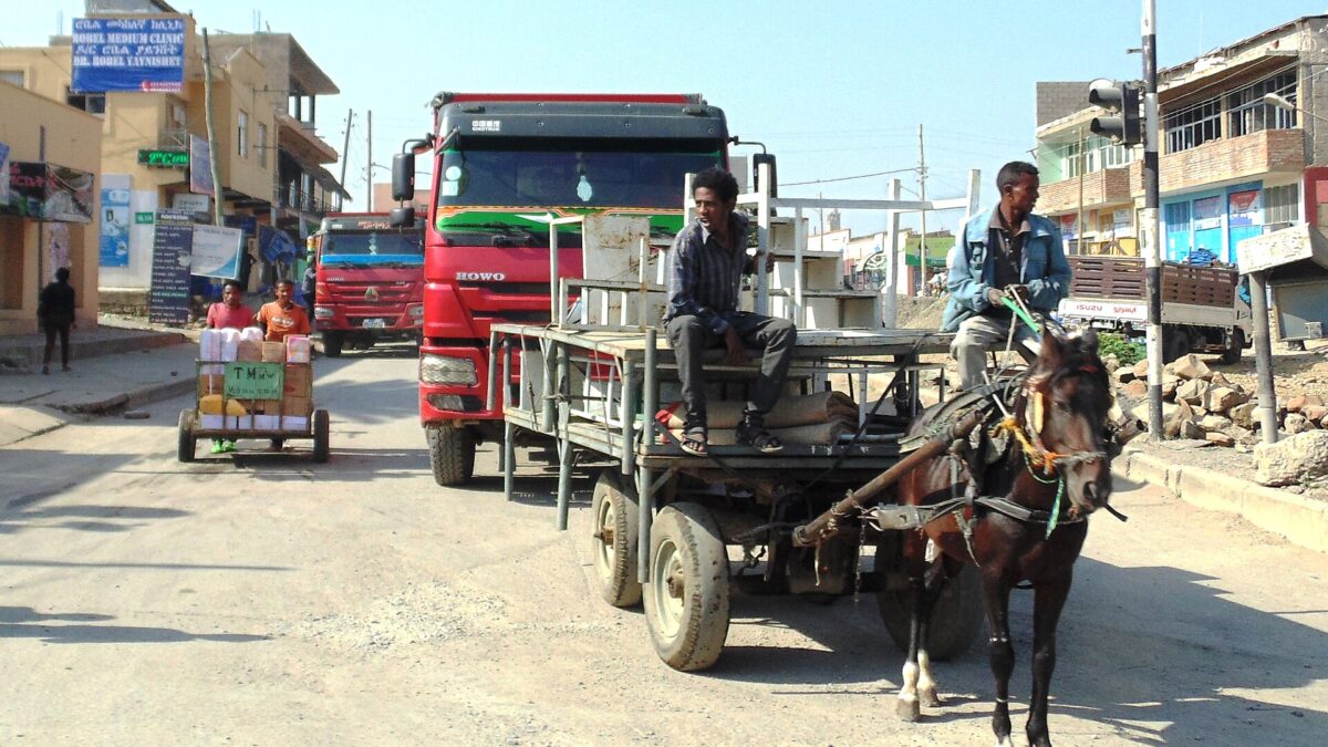 A street scene in Mekelle, the capital of Ethiopia's Tigray region, with trucks and a horse-drawn cart