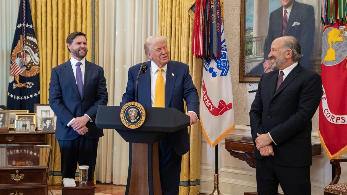 President Donald Trump speaks at a lectern in the Oval Office as Vice President JD Vance looks on (file photo)