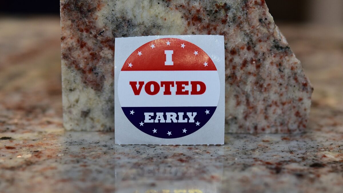An “I Voted Early” sticker propped against a granite block