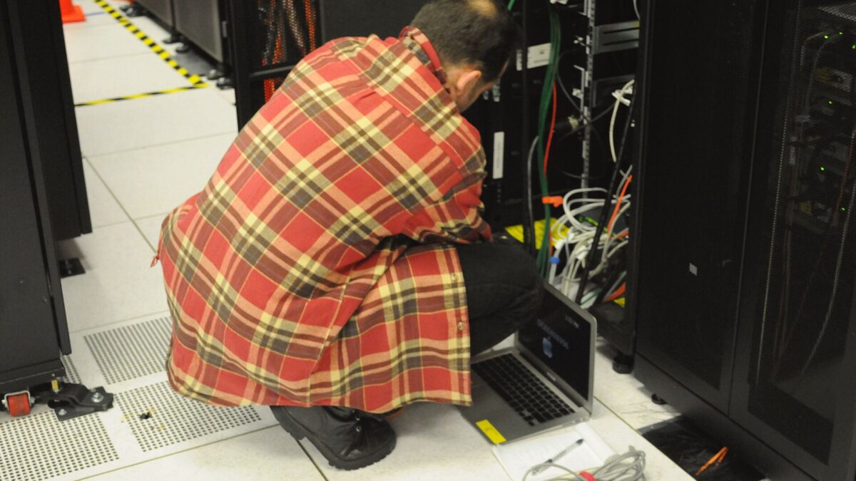 Technician working on a server rack in a data center