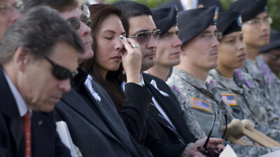 Family members and soldiers attend the Nov. 10, 2009, memorial service at Fort Hood, Texas, honoring victims of the shooting